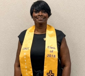 Portrait of Sibyl Gibson wearing a graduation stole during her chaplain ministry journey