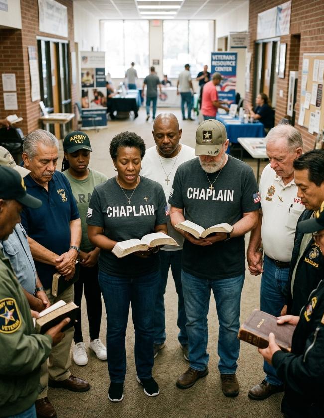Veteran chaplains leading a prayer circle with military veterans while holding Bibles at a community veterans center.