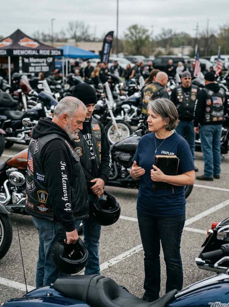 Female motorcycle chaplain praying with riders during a memorial ride gathering